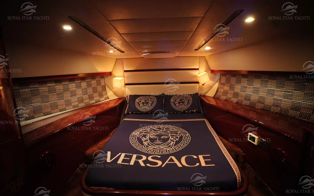Cozy bedroom with Versace bedding inside Al Shali yacht