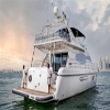 Rear view of 75 FT Mayyas yacht with crew onboard in Dubai waters