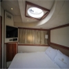 Master bedroom with TV and wide bed inside 75 FT Mayyas yacht