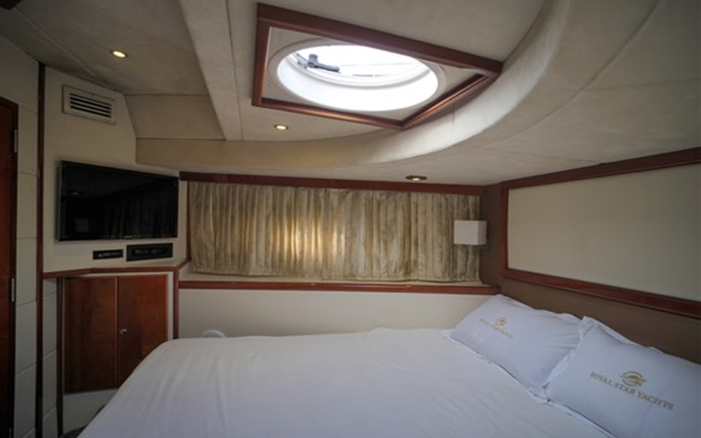 Master bedroom with TV and wide bed inside 75 FT Mayyas yacht