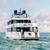 Rear view of luxury yacht with crew in Dubai