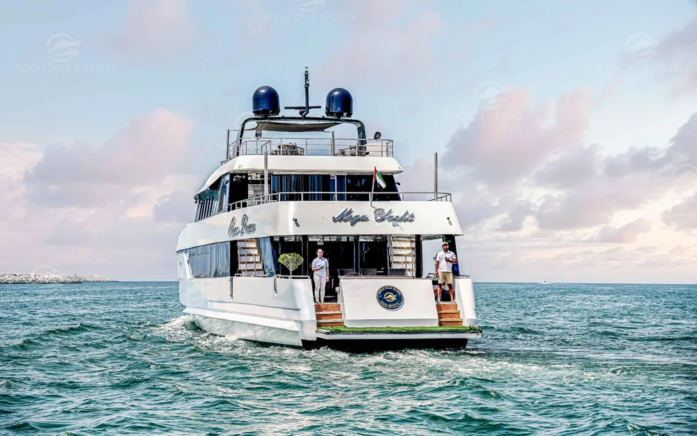 Rear view of luxury yacht with crew in Dubai