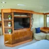 Bedroom with TV and lounge chairs in 101 FT Majesty yacht