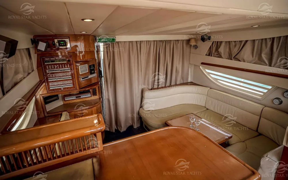 Wood finish cabin area with dining space inside Enterprise yacht Dubai