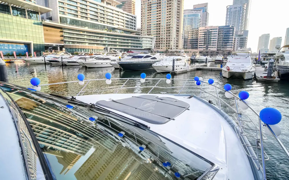 Front view of 59 FT Majesty yacht decorated with blue balloons in Dubai Marina